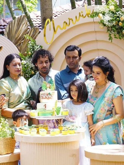The cake cutting ceremony at Charvik's safari party, with the family gathered around the beautifully themed dessert table.