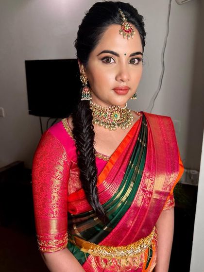 The complete look is both traditional and fresh. The intricate braid and classic makeup create a stunning bridal profile.