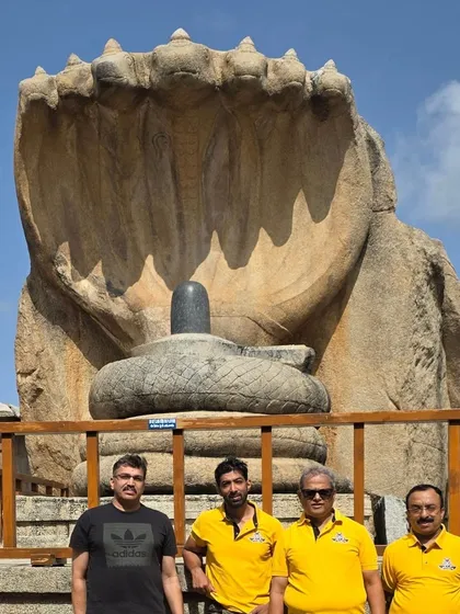 Our group in front of the massive Naga Linga statue at Lepakshi. These heritage tours are not just about riding; they are about experiencing the scale and stories of South Indian history together.