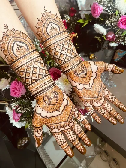 Another angle of this intricate bridal design, showing how the patterns flow seamlessly from the palm to the wrist and forearm.