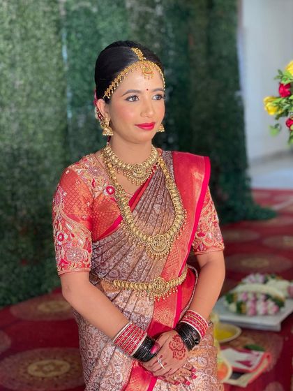 The bride in her full wedding attire, looking poised and ready for her ceremony. The makeup is long-lasting to withstand the emotions and rituals of the day.