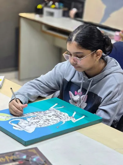 A young artist working diligently on her project. We encourage focus and dedication in a supportive and friendly environment.