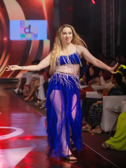 A dancer in a vibrant blue costume performs at IMODA 2025. This shot freezes a moment of graceful movement, highlighting the costume and the performer's expression.