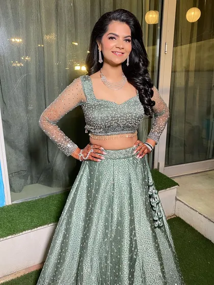 A full-length view of this gorgeous bride-to-be. Her sage green lehenga is so unique, and the glamorous makeup makes her look absolutely ready for her engagement party.
