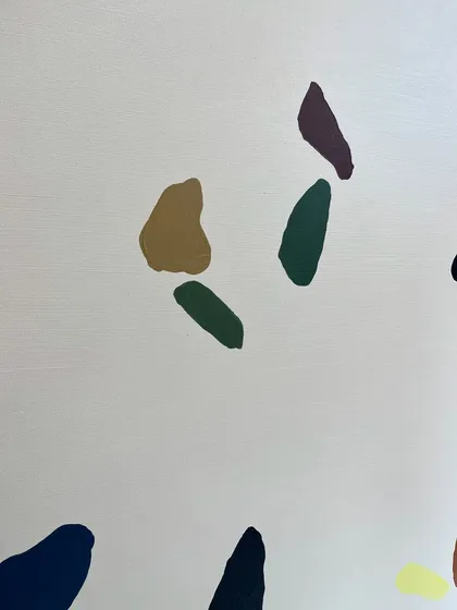 A close-up of the colorful abstract shapes. Each one is carefully painted to look like a natural stone fragment found in terrazzo flooring.