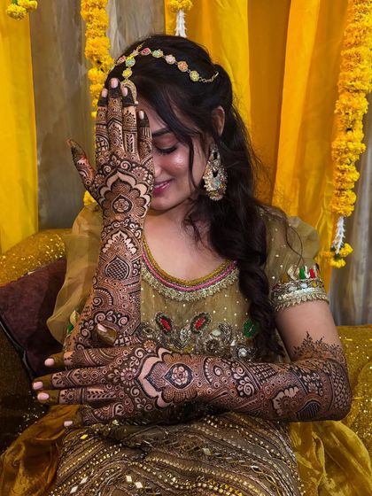 A classic shy bride pose, with the intricate back-hand design beautifully framing her face.