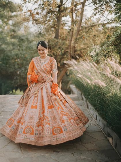 A radiant bride walking in a sunlit garden. The beautiful flare and natural setting create a dreamy and romantic portrait.