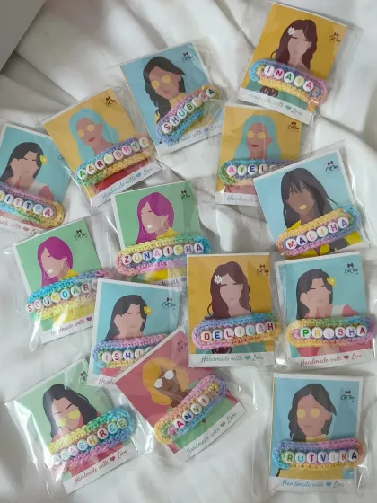 A large batch of our personalized name clips, each attached to a cute illustrated card. These are on their way to a birthday party as return favors.