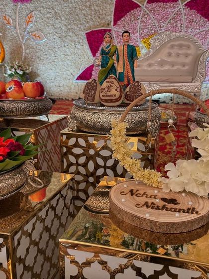 A personalized wooden plaque with the couple's name, part of a custom ring platter for an engagement.