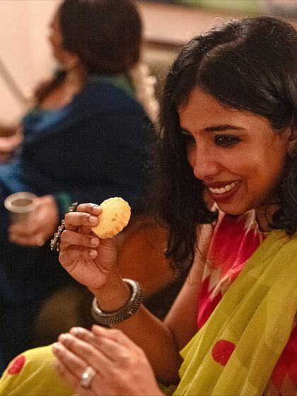 A guest enjoying one of our savory shortbreads during a Diwali get-together.