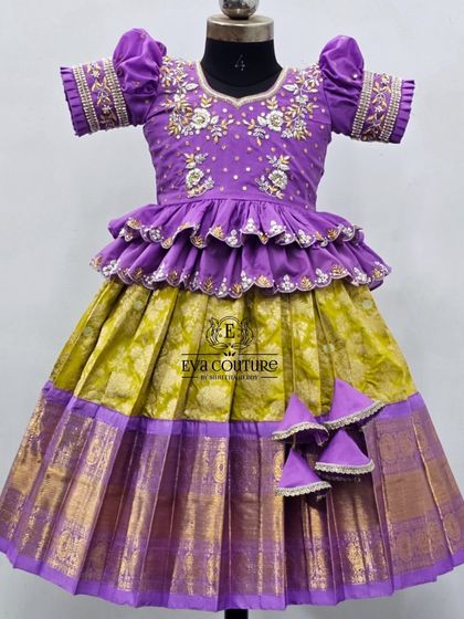 A closer view of the purple and lime green lehenga, highlighting the detailed embroidery on the sleeves and blouse.