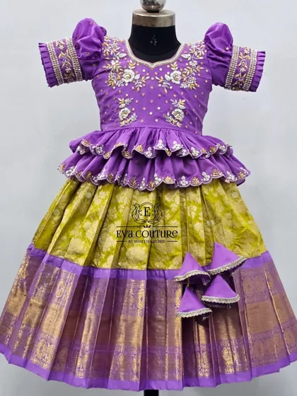 A closer view of the purple and lime green lehenga, highlighting the detailed embroidery on the sleeves and blouse.