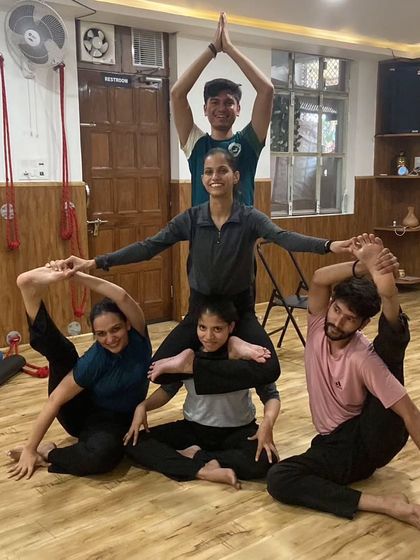 Another impressive group acro yoga formation. This requires immense trust, balance, and coordination from every single person.