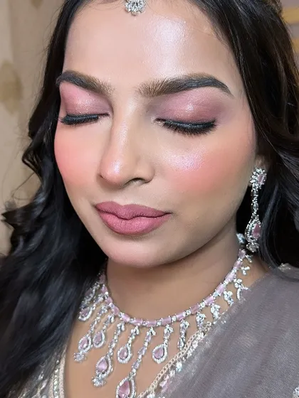 A close-up of the soft pink eye makeup. The shimmer is concentrated on the lid for a pop of light, while the rest of the eye is kept soft and blended.