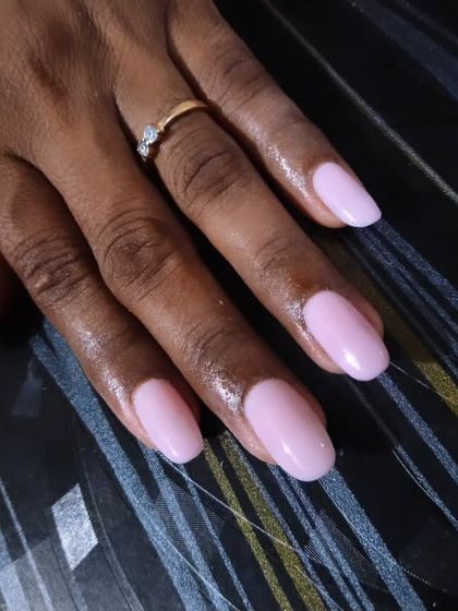 A classic and clean set of gel extensions in a beautiful milky pink shade. This simple, solid color on well-shaped nails is the definition of elegance and sophistication.