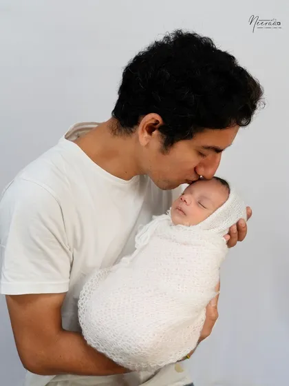 A father's promise of protection and love, sealed with a gentle kiss. These simple, powerful moments between a father and his newborn are truly priceless.