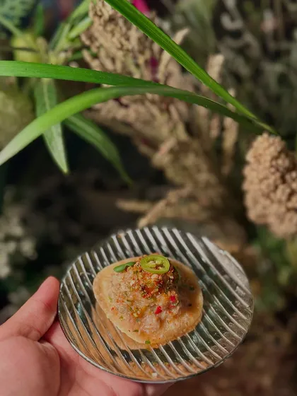 A modern take on a classic Indian street food, this appetizer features a crispy base topped with a flavourful mixture.