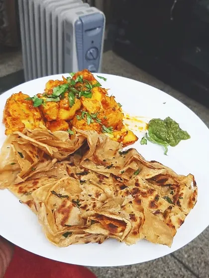 A simple, wholesome meal of Aloo Gobhi Masala served with a flaky lachha paratha and our fresh green chutney. This is a classic North Indian combination that always hits the spot.