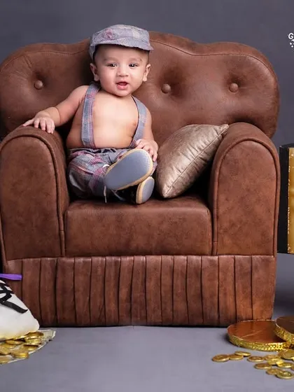 I'm the boss! This little guy means business, sitting in his leather armchair with his laptop and bags of money.