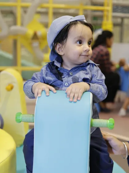 Even the littlest adventurers have a great time. A toddler enjoys a ride on a rocking toy in our dedicated soft play area for ages 1-4.