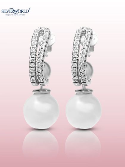 A modern take on pearl earrings, this pair features a classic pearl drop suspended from a zirconia-encrusted huggie hoop. It's the perfect blend of classic and contemporary.
