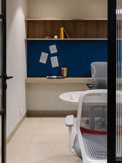 A private cabin in the Vision office, viewed through a fluted glass door. This provides privacy while still allowing light to filter through, maintaining a connection to the larger office.