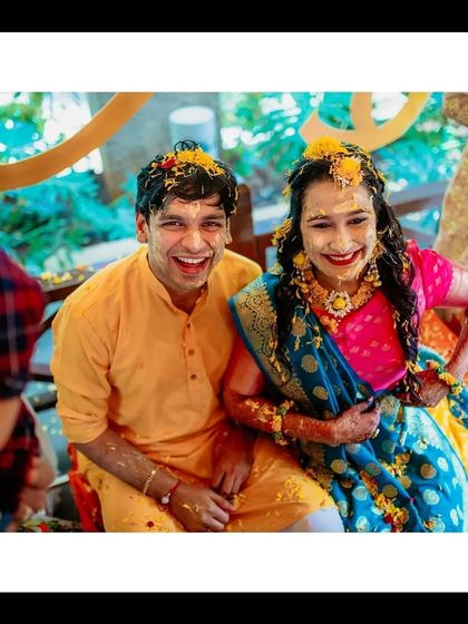 A happy portrait of the couple during their Haldi ceremony, covered in turmeric and surrounded by love.