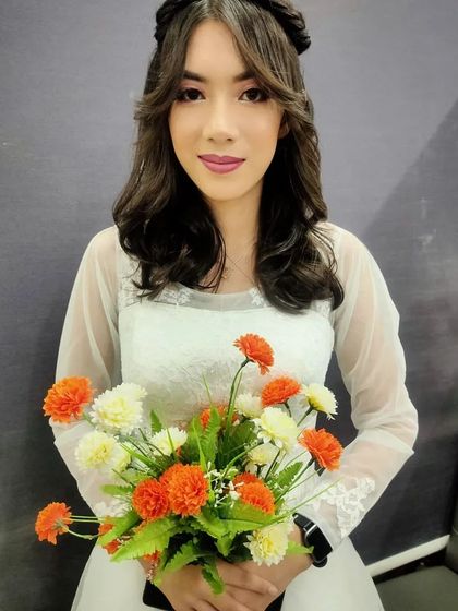 A duplicate of image 22, showing the full composition of the contemporary bridal look with a bouquet.