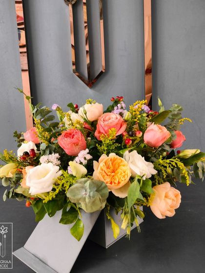 The soft, peachy tones and gentle shapes in this arrangement create a mood of calm and romance. Every element is chosen to contribute to this feeling.