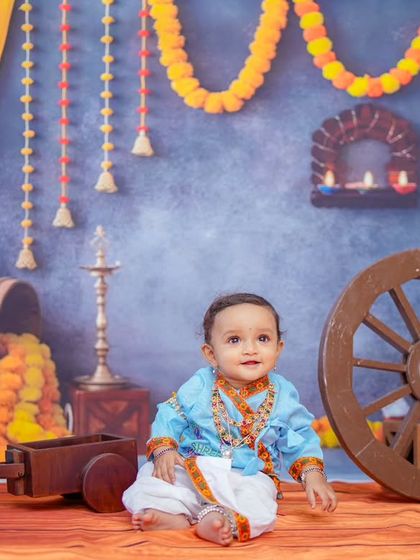 This shot showcases the full, colorful backdrop and the baby's adorable expression. Themed shoots are a fantastic way to celebrate important milestones and create unique photographs.