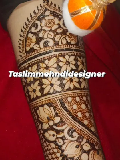 A close-up of a detailed floral band on the arm. The mix of bold and fine lines creates a beautiful texture.