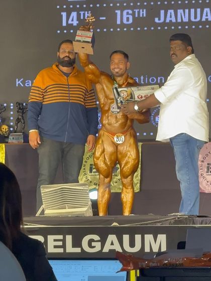 Receiving the second-place trophy at the IBBF Mr. India 2025. A proud moment with my Guruji, who made it all possible.