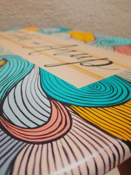 A close-up on the swirling, colorful patterns of the "Natya and Anup" name plaque, showcasing the detailed line work and vibrant boho palette.