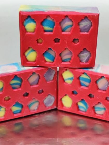 A peekaboo design featuring tiny, colorful cupcakes embedded in the soap.