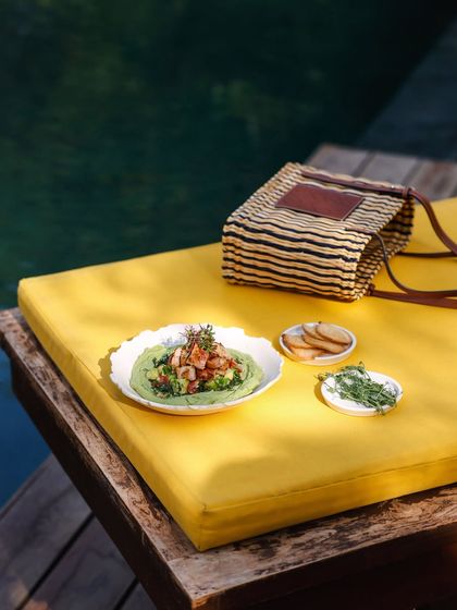 A light and healthy poolside snack, featuring a vibrant green dip with shrimp, perfect for a sun-drenched afternoon.