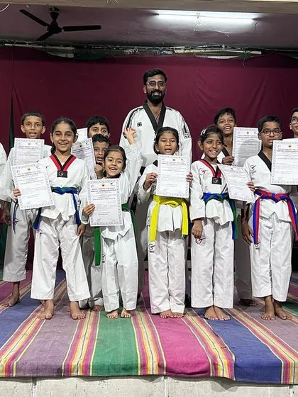 A proud group of our female students on stage after receiving their new belts. Their achievements highlight the growing strength of women in Taekwondo.