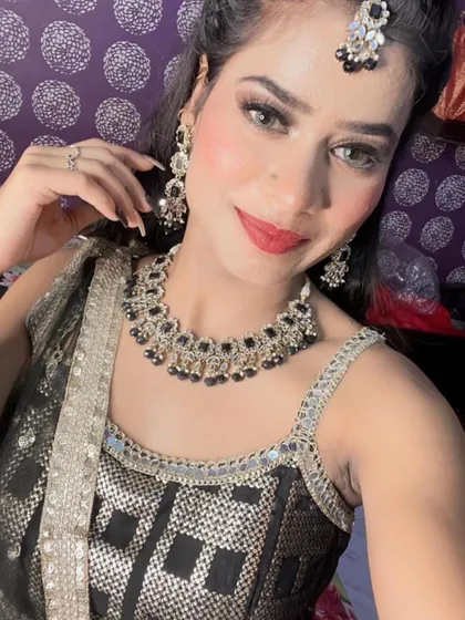 A close-up selfie showing off a beautiful black and silver rental jewellery set. It includes a choker, matching earrings, and a maang tikka, perfect for a sangeet or reception.