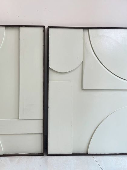 A straight-on view of the white minimalist diptych. The composition is abstract and geometric, designed to create a sense of calm and order.