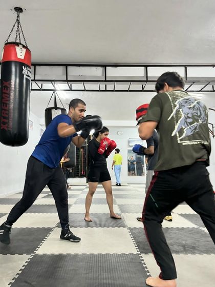 The gym is full of energy during our group training sessions. Here, multiple pairs are engaged in various drills, creating a dynamic learning atmosphere.