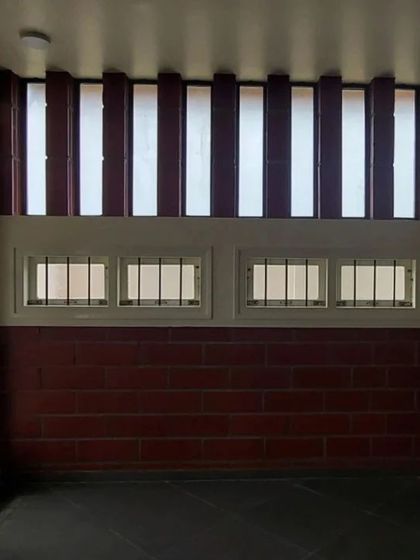 A room featuring a combination of low windows and high, louvered vents for excellent cross-ventilation.