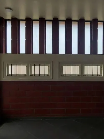 A room featuring a combination of low windows and high, louvered vents for excellent cross-ventilation.