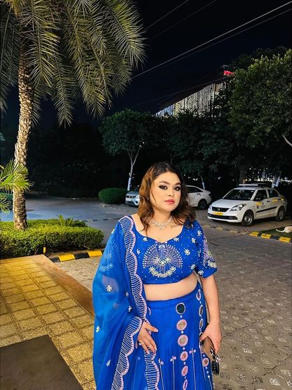 A full-length shot of the client in her blue lehenga, ready for a night of celebration. This shows how my outfits are perfect for any party setting.