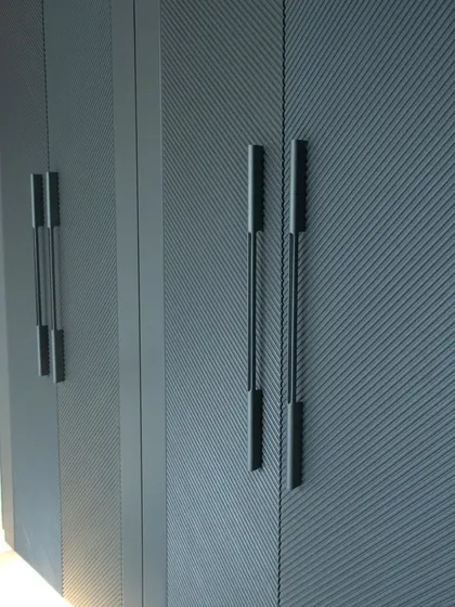 A detailed view of the textured finish and long profile handles on our dark grey wardrobe. This combination adds both visual interest and a satisfying tactile experience.