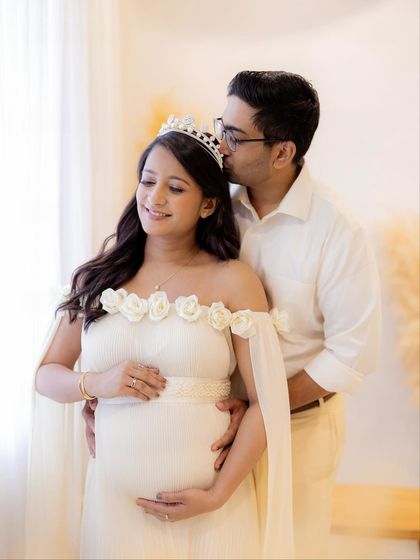 A sweet forehead kiss for the mommy-to-be, crowned like the queen she is. These are the precious, heartfelt moments that make a couple's maternity session so magical.