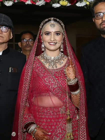 A lovely shot of the bride making her entrance, surrounded by her family.