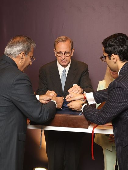 A ceremonial moment at our Zegna event, as our leadership and the Italian Ambassador unveil an exclusive fabric collection. This signifies the deep respect and partnership between our brand and the heritage of Italian craftsmanship.