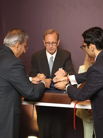 A ceremonial moment at our Zegna event, as our leadership and the Italian Ambassador unveil an exclusive fabric collection. This signifies the deep respect and partnership between our brand and the heritage of Italian craftsmanship.