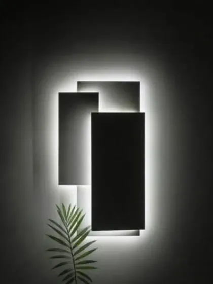 A minimalist wall light that uses geometric shapes and backlighting to create a soft, ambient glow.