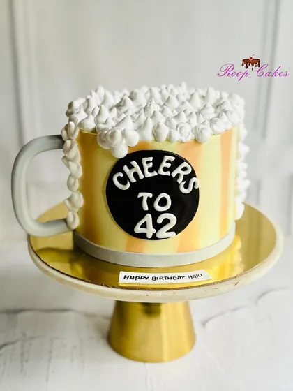 Cheers to 42. A fun beer mug-themed birthday cake, complete with frothy whipped cream foam, to celebrate in style.