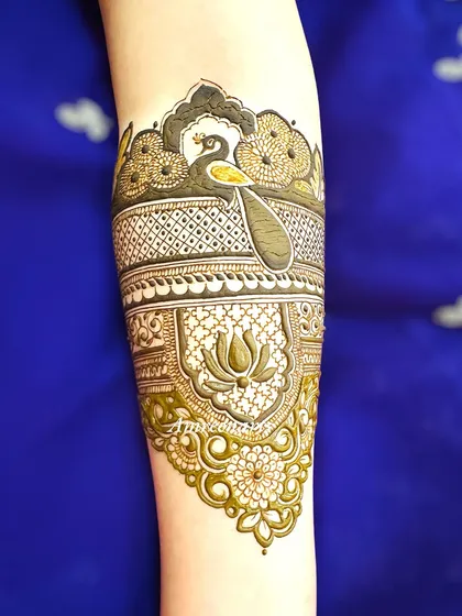 An intricate arm band design combining a peacock, lotus, and delicate floral work.